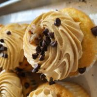 Chocolate Chip Cookie Dough Cupcake · Vanilla cake with a chocolate chip cookie inside topped with cookie dough molasses buttercre...