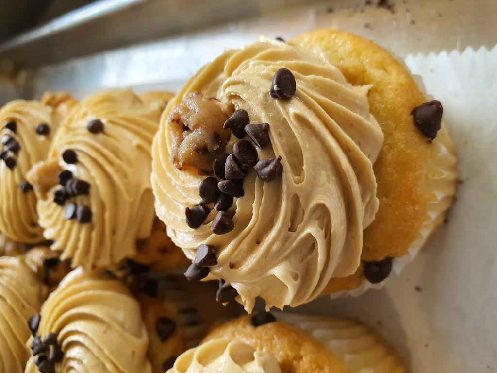 Chocolate Chip Cookie Dough Cupcake · Vanilla cake with a chocolate chip cookie inside topped with cookie dough buttercream.