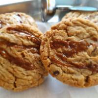 Salted Caramel Chunk Cookie · Soft and chewy cookie with gooey caramel bits and chocolate chunks topped with sea salt.