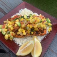 Rick’s Slammin’ Salmon · Grilled salmon topped with mango avocado salsa & served on a bed of jasmine rice.
