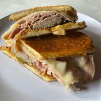 Cubano Sandwich · Roasted pork, ham, swiss cheese, pickles, spicy mustard on a long roll.