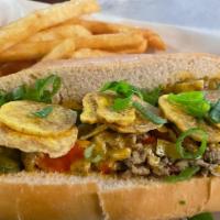 Jerk Chicken Cheesesteak · Shaved chicken with jerk seasoning, peppers, onions and cheddar cheese topped with green oni...