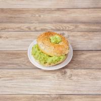 Avocado Toasted Bagel · Toasted bagel topped with a creamy avocado spread drizzled with honey.
