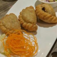 2. Curry Puff · Combination of Thai pastry stuffed with ground chicken, potatoes, onions and curry powder.