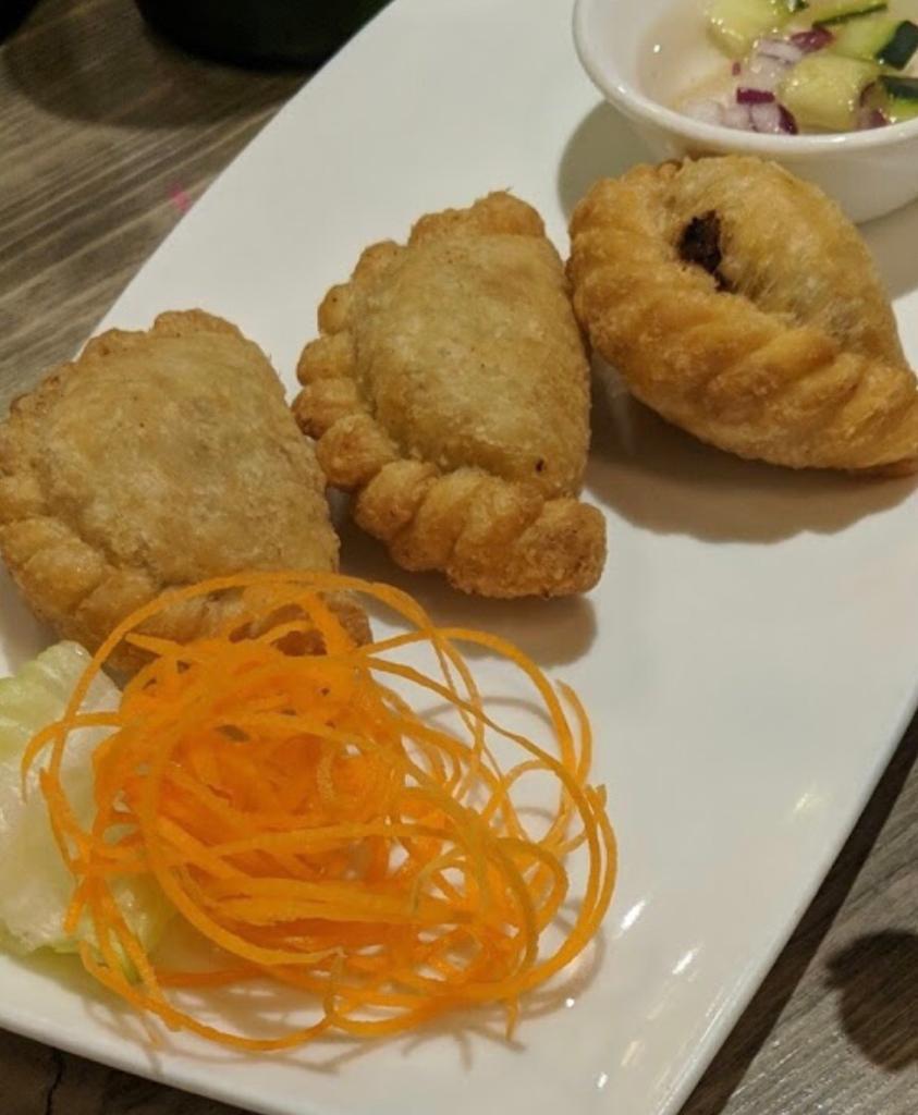 2. Curry Puff · Combination of Thai pastry stuffed with ground chicken, potatoes, onions and curry powder.