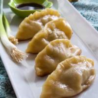 6. Pork Pot Sticker · Homemade pan-fried pork dumpling. Served with water chestnuts in ginger with soy dipping sau...