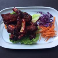 13. Beer-Braised Crispy Ribs · Served with a spicy tamarind glaze.