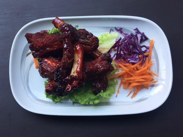 13. Beer-Braised Crispy Ribs · Served with a spicy tamarind glaze.