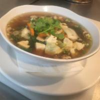 25. Tofu Soup · Delicate homemade clear soup with fresh tofu, mushroom, scallion, carrots, cabbages and garl...