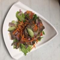 35. Char Beef Salad · Nam tok-grilled marinated beef with scallion, mint, tomatoes and cucumber tossed in lemongra...