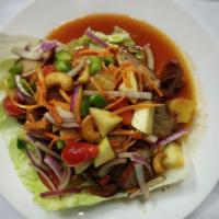 38. Crispy Duck Salad · Crispy duck with herbs, red onions, scallion, green leaf pineapple, cashew nuts, cilantro an...