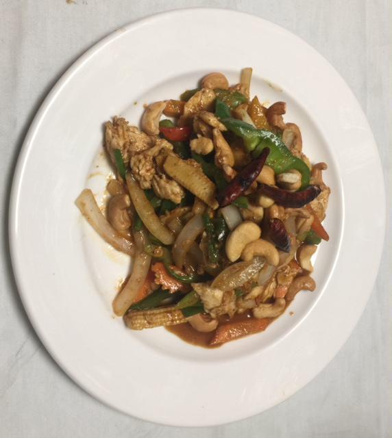 50. Pad Cashew · Sauteed cashew, onion, scallions, bell peppers, carrots, celery, baby corn and dried chili with brown sauce. Spicy.