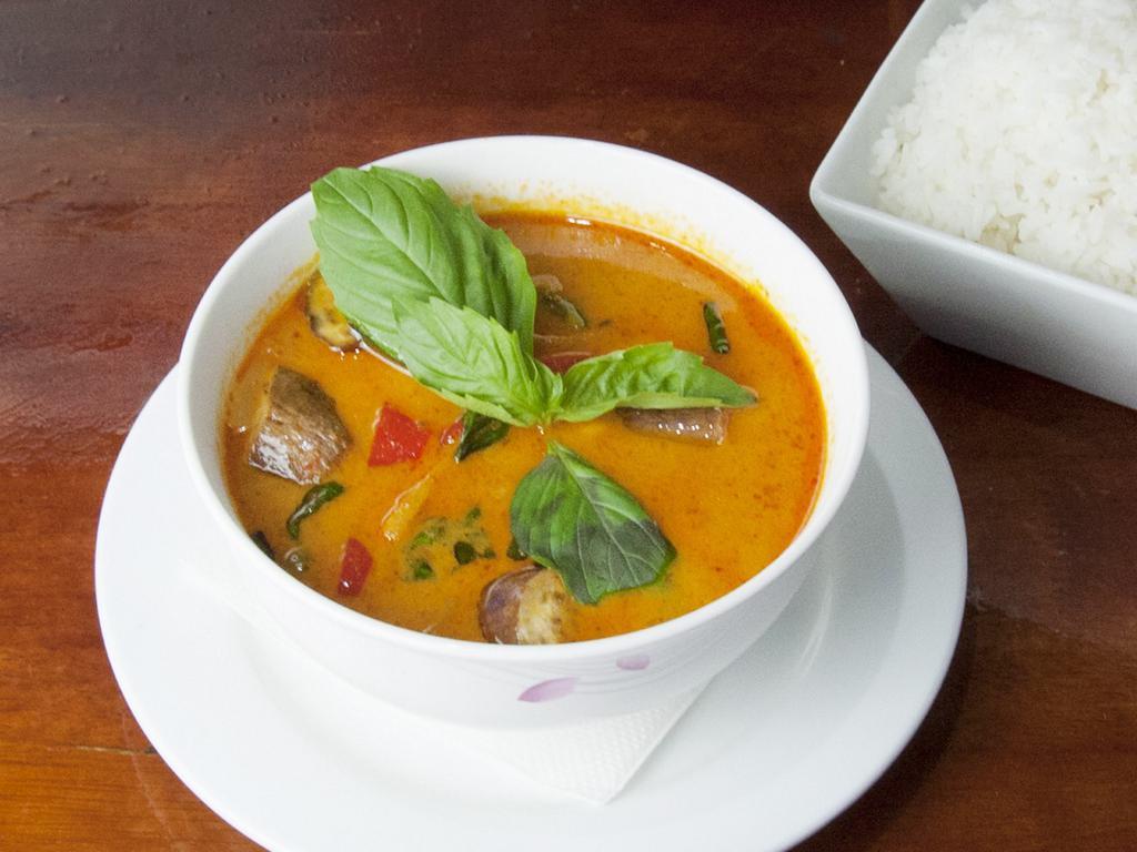 64. Red Curry Spicy · Eggplant, bell pepper, basil and bamboo shoot in coconut red curry. Spicy.