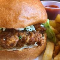 Fried Chicken Sandwich · Buttermilk chicken with a perfect crust. Served on a brioche bun with chipotle remoulade, ra...