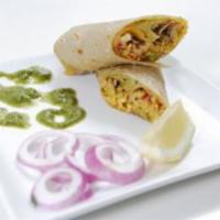 Paneer Bhurjee Kathi Roll · Grated Indian cheese with tomatoes and peas, garnished with mint-cilantro chutney and red on...