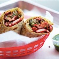 Chicken Tikka Kathi Roll · Chicken marinated in spiced yogurt and garnished with mint-cilantro chutney and red onions. ...