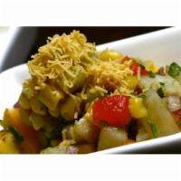 Aloo Papri Chaat · Spiced potatoes layered with papri, onions, tomatoes, tamarind chutney, mint-cilantro chutne...