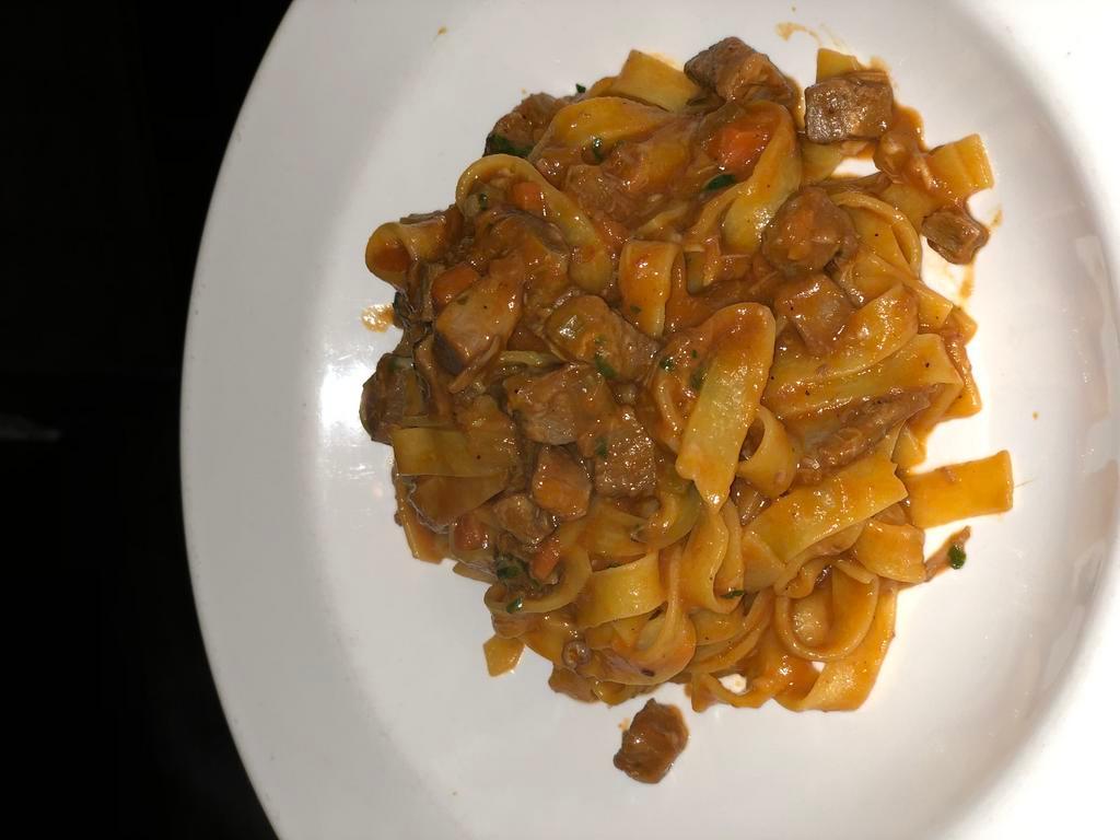 Tagliatelle with Duck Ragu · Flat pasta with our own duck breast ragu.