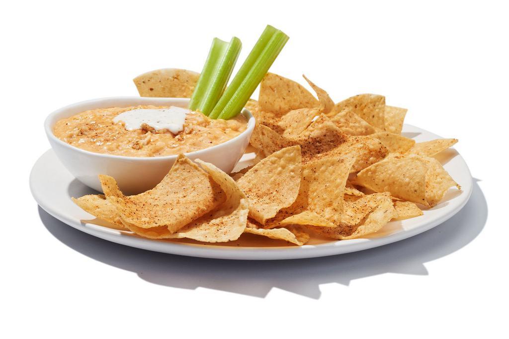 Hooters Original Buffalo Chicken Dip · Who’s got tender, shredded chicken, spicy Buffalo sauce and creamy melted cheese? This guy! We top the whole thing with your choice of ranch or bleu cheese. Comes with warm, seasoned tortilla chips for dippin’.
