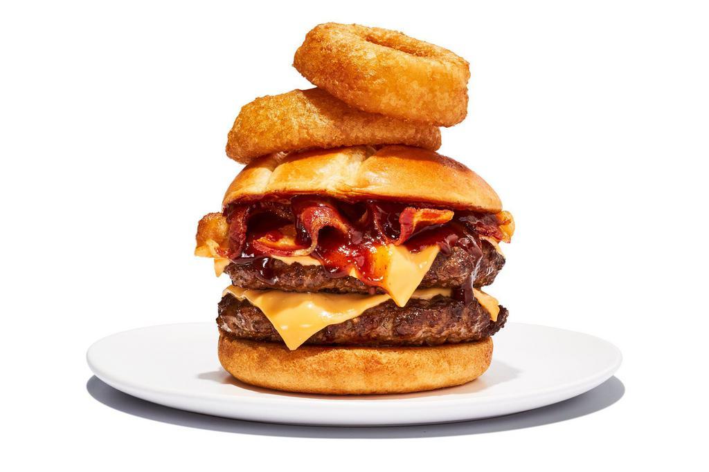 Western BBQ Burger · 2 1/4 lb. patties. It’s like a burger with spurs. BBQ sauce, melted cheddar, bacon, and onion rings all wrangled into a toasted brioche bun.