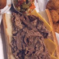 Italian Beef · Composed of thin slices of seasoned roast beef, simmered and served on a long Italian-style ...