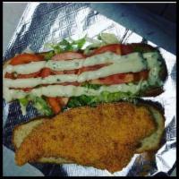 Fish Sandwich · Served with lettuce, tomatoes, and tartar sauce.