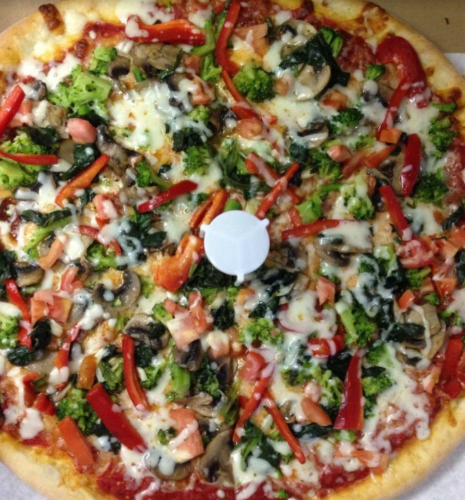 Vegetarian Pizza · Sauteed mushroom, fresh broccoli, spinach, roasted peppers, fresh tomatoes and fresh roasted garlic topped with a blend of mozzarella cheese.