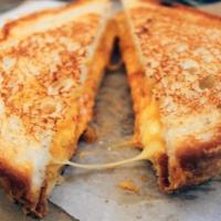 Three Cheeses Grilled Cheese Sandwich · Homemade bread, American, Cheddar and Swiss cheese.