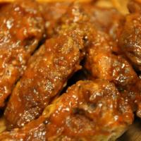 Kickin Jamaican Wings · Hot and spicy. Hand tossed in Jamaican jerk seasoning blend, fresh garlic, ginger and jalape...