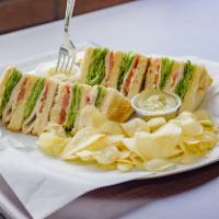 Turkey Club Sandwich · With lettuce, tomato and bacon. Served with pickles, coleslaw and chips.