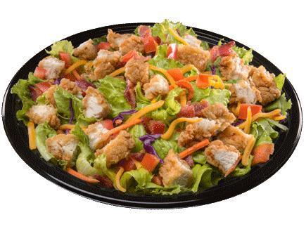 Crispy Chicken Salad · Our signature chicken strips, served hot and crispy, diced and placed on a crisp blend of romaine and iceberg lettuce. Topped with diced tomatoes and cheddar cheese. Includes honey mustard or choice of dressing.
