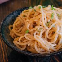 Garlic Noodles · Thin noodles sauteed with our soy-garlic sauce and garnished with green onion.