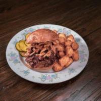 Smoked Brisket Sando · Tillamook Vintage Cheddar Pimento, Crispy Onions, House BBQ + Aioli on a Brioche Bun