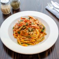 Pasta Primavera · Fettuccine with zucchini, mushrooms, spinach and peppers in a pink, parmigiano cream sauce.
