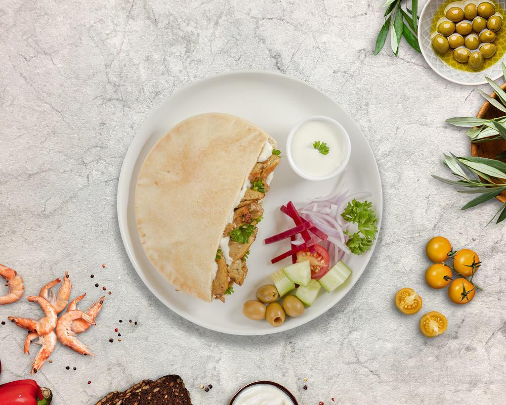 Chicky Shawarma Wrap · Boneless chicken thigh meat marinated in a mediterranean blend of herbs and spices served in a Lavash pocket with hummus, tahini sauce, pickles, and your choice of salad.