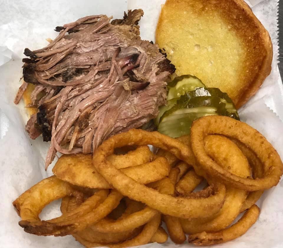 Huron River Pig · Our yummy pulled pork with thick applewood bacon, Dearborn ham American cheese, our Carolina sauce, and topped with an onion ring.