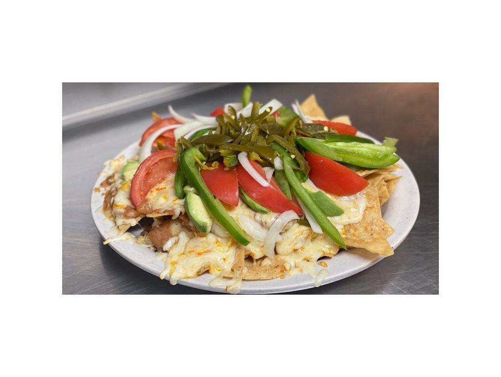 Small Botana · Corn chips with chorizo beans, cheese, avocados, tomatoes, green peppers, onions, olives and jalapenos