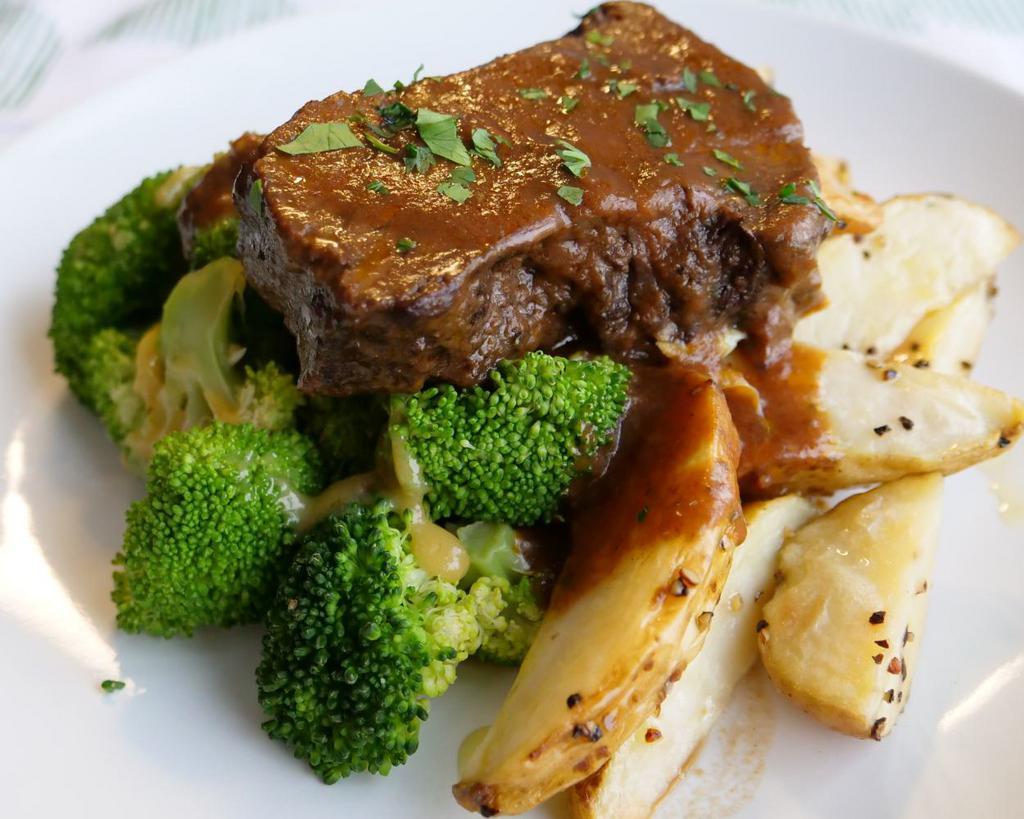 Barbacoa Pot Roast · Slow-cooked grass-fed beef chuck simmered in an aromatic gravy and served in a smoky au jus, served with chef recommended potato spears and roasted broccoli (substitutions available)