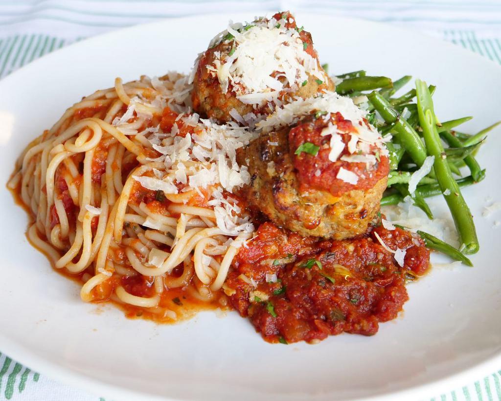 Spaghetti & Market Meatballs Marinara · Two luscious pork and beef meatballs slathered in house marinara sauce, shaved parmigiano and herbs, shown and labeled with chef choice green beans (substitutions available).