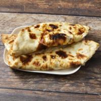 Naan · Leavened flat bread baked in the clay oven.