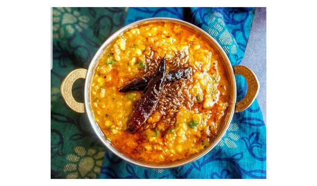Tadka Dal · Split lentil cooked with ginger, turmeric and tomatoes then tempered with mustard seed, onion and garlic.