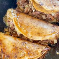 Taco de Birria Ahogado · Corn tortilla, cheese, birria, cilantro & onions.
