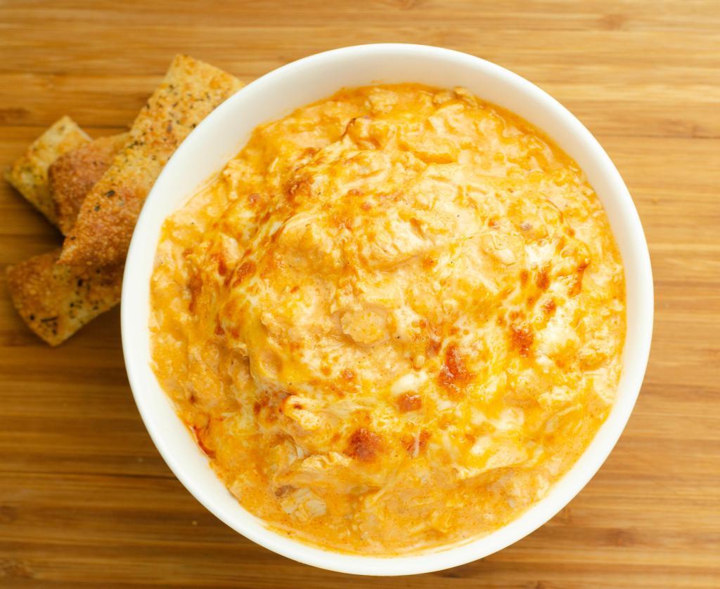 Buffalo Chicken Dip · Spice up your night! Try our signature Buffalo Chicken Dip made with tender chicken, buffalo sauce, sour cream and a variety of cheeses. Served with an 8