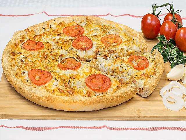 Vegan White Pizza · Olive Oil • Onions • Fresh Garlic • Oregano • Black Pepper • Salt • Daiya Mozzarella Cheese • Sliced Tomatoes