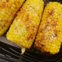 Cajun Lime Corn · Grilled in a  Cajun lime butter. Topped with a chilli, lime salt and served with a lime.