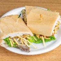 Pan con Bistec Sandwich · Steak, lettuce, tomatoes, crunchy fries, and onions on Cuban bread.