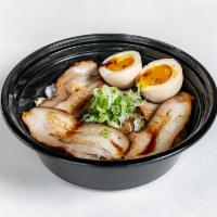 Chashu Don · Sliced roasted pork belly over white rice with a boiled egg mustard sauce and scallions.