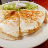 Chicken Quesadilla · Flour tortilla filled with cheese, chicken Served with lettuce and sour cream on the side.