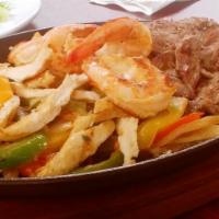 Mixed Fajita · Chicken, shrimp, and beef over onions and bell peppers. Served on a skillet with three flour...