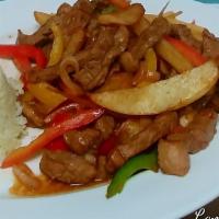 Lomo Saltado · N.Y. steak, sauteed with soy sauce, vinegar, onion, tomatoes, bell peppers, and french fries...